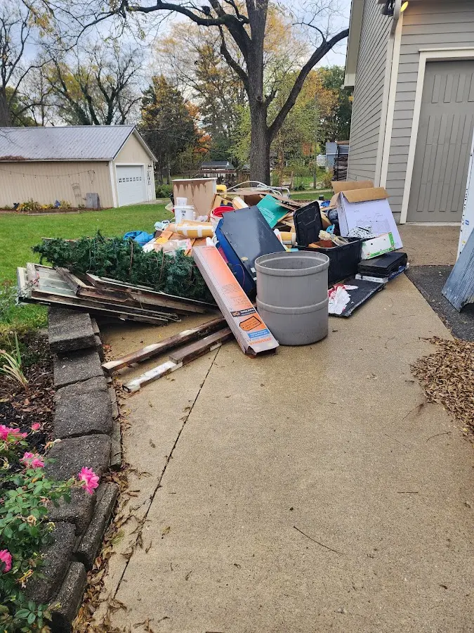 Dumpster being loaded with debris for Estate Cleanout Dumpster Rental in Barbourville